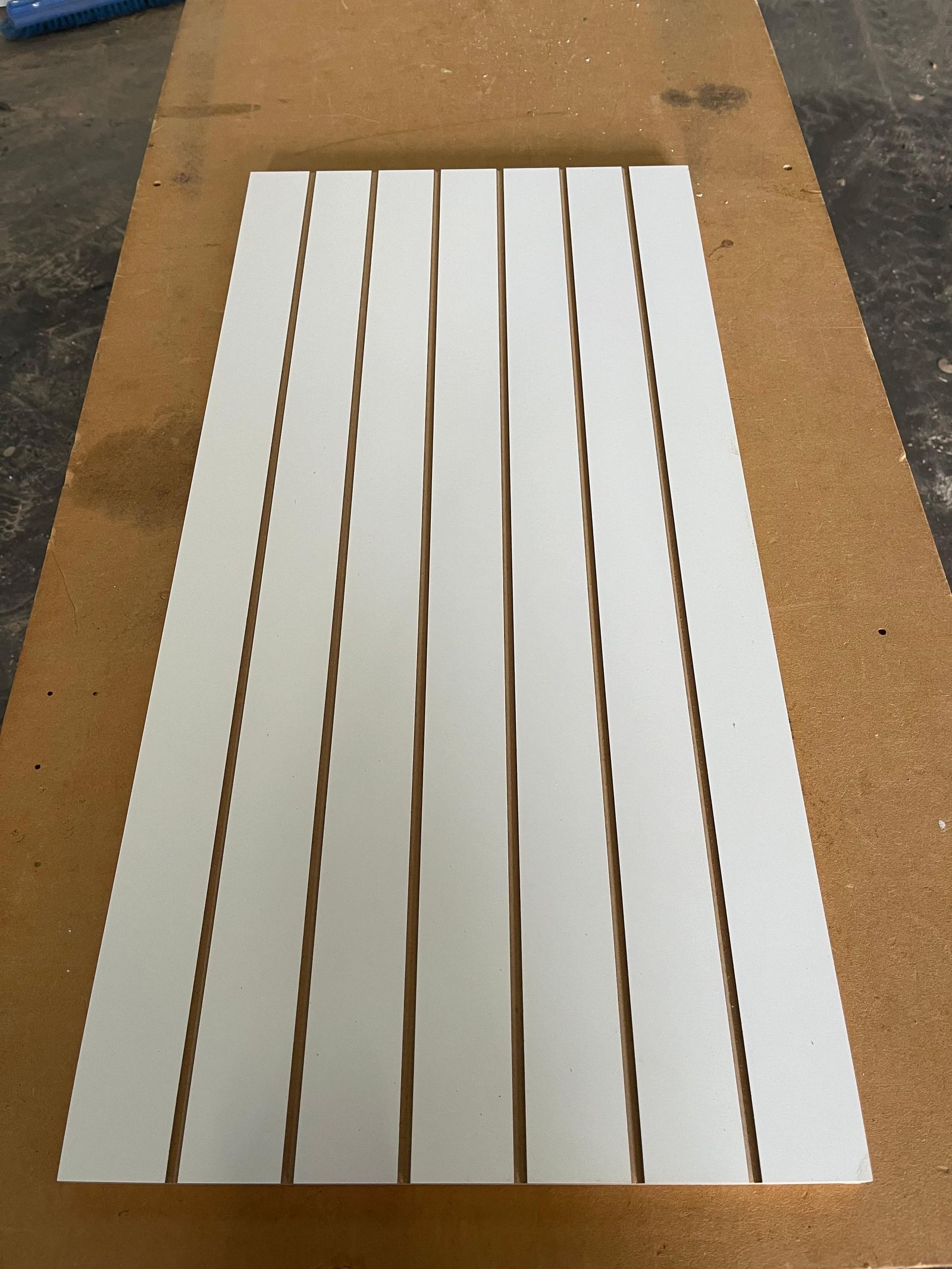 CNC-cut slatted timber panels ready for edging and assembly