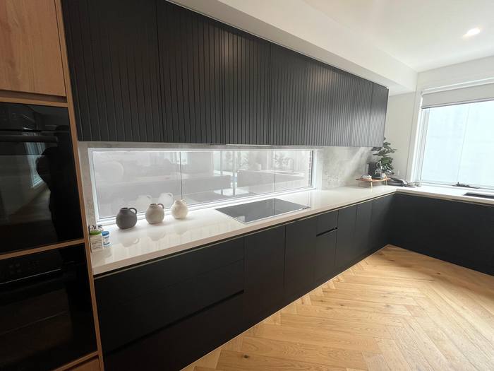 Black kitchen with under-cabinet lighting