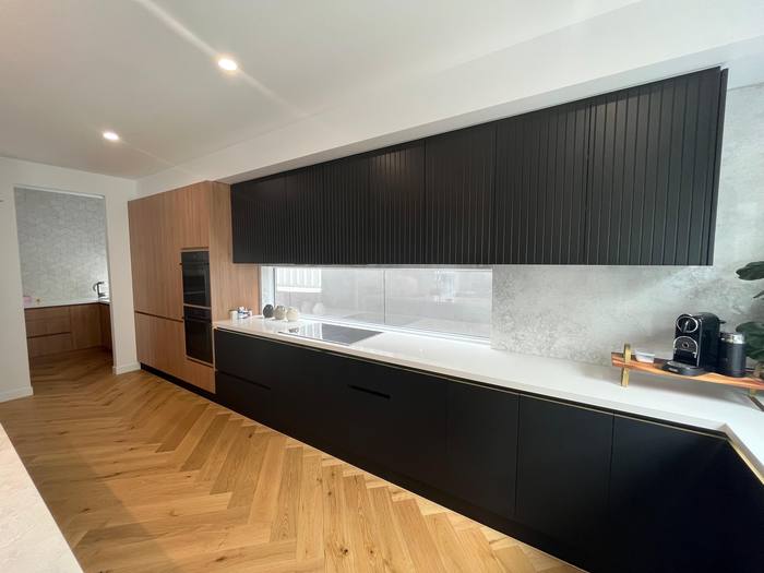 Black kitchen with herringbone floor