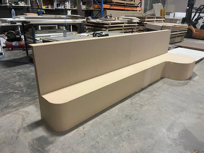 Curved commercial shopfitting counter finished in cream
