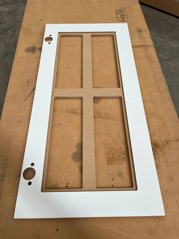 Precision pre-drilled cabinet panel showing CNC hardware holes