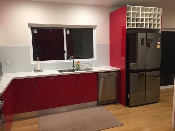 Red gloss kitchen with integrated fridge