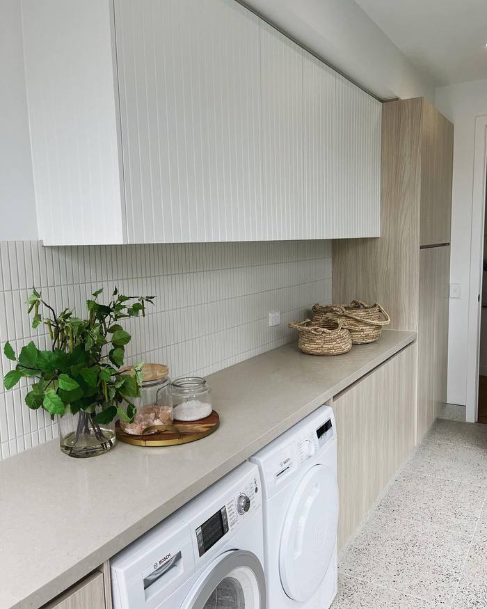 Laundry cabinetry with integrated appliances